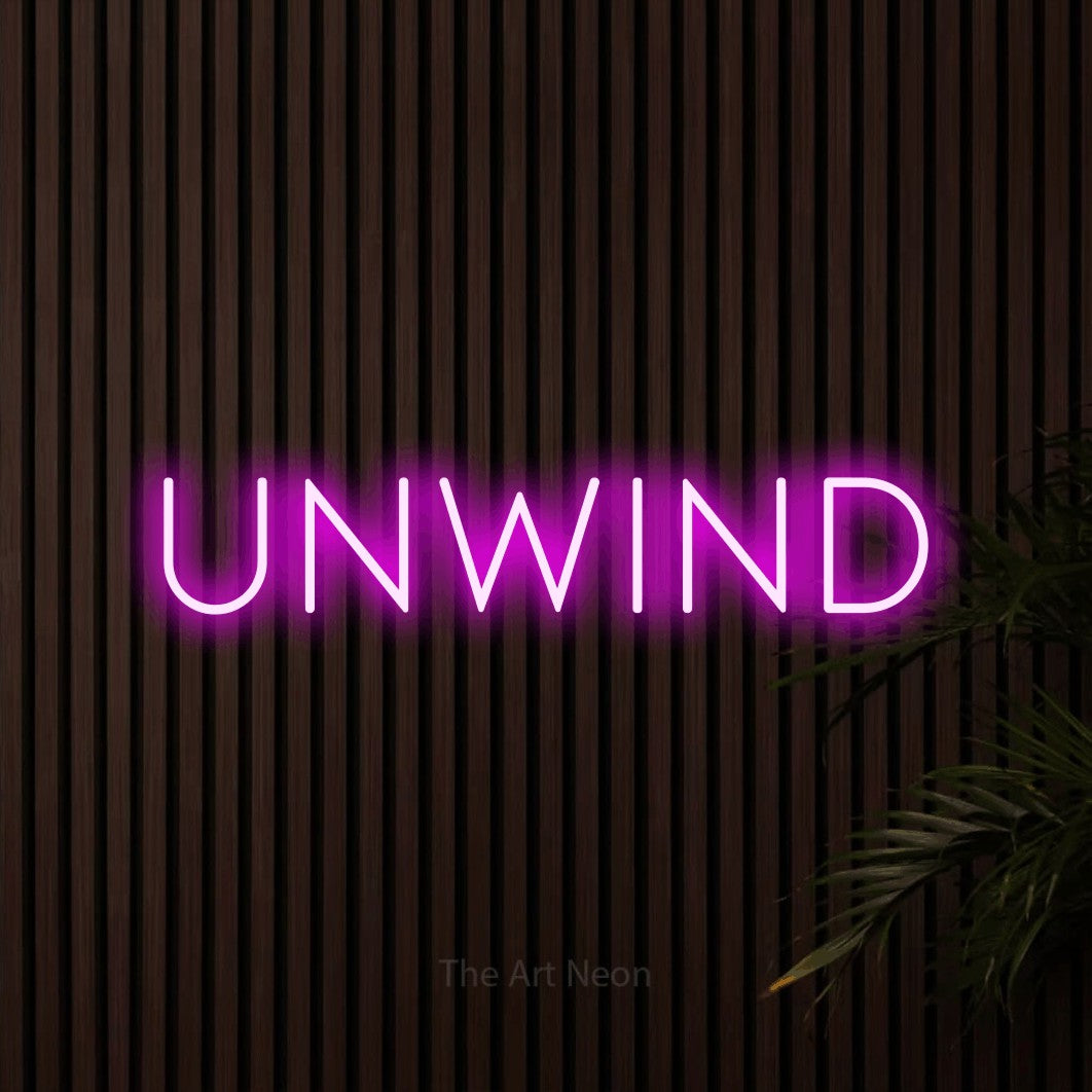 Pink LED neon sign reading "Unwind" against dark wooden slats for bedroom décor