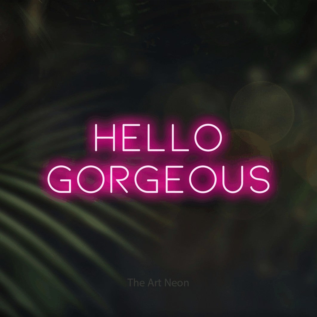 Hot pink LED neon sign reading "Hello Gorgeous" against dark blurred palm leaves for bedroom décor