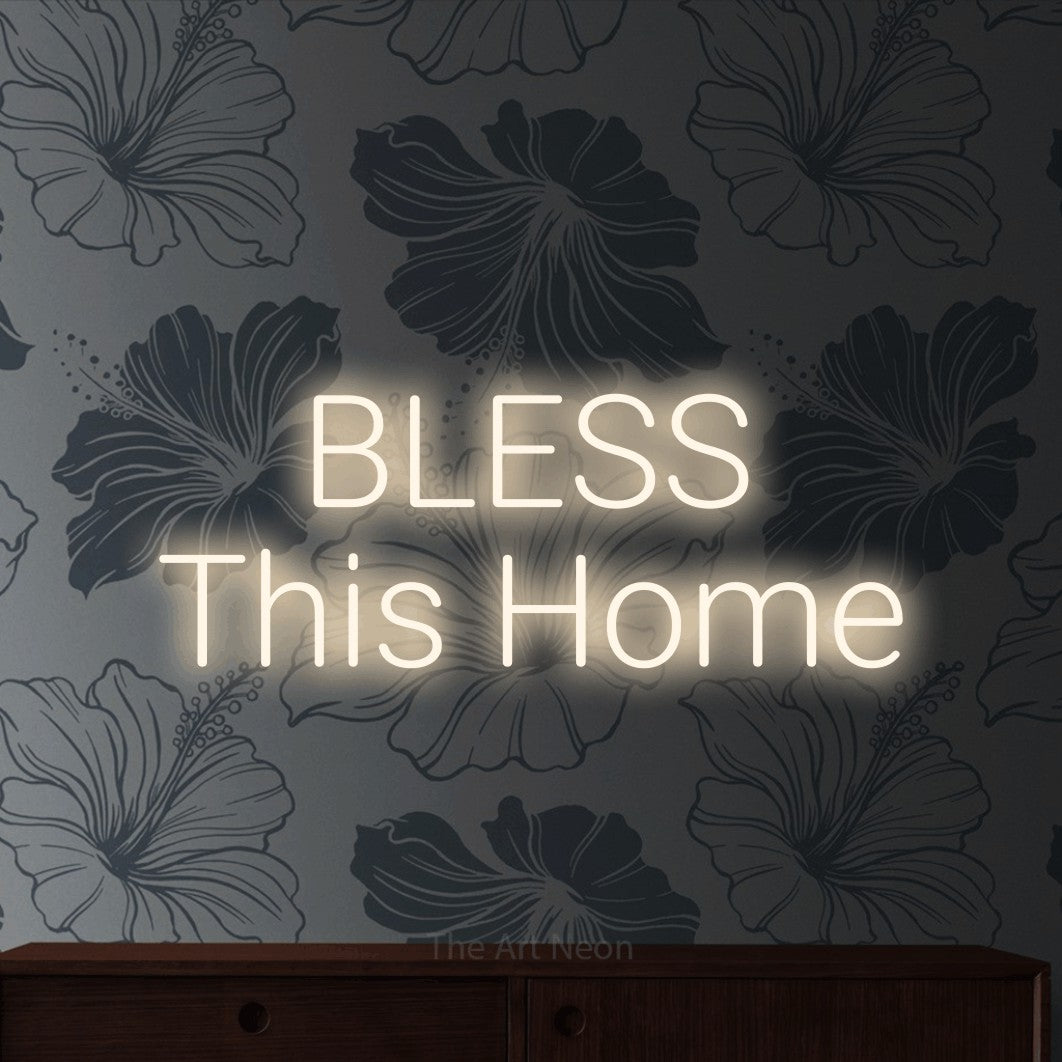 Warm white LED neon sign reading "Bless This Home" against grey floral wallpaper for living room décor