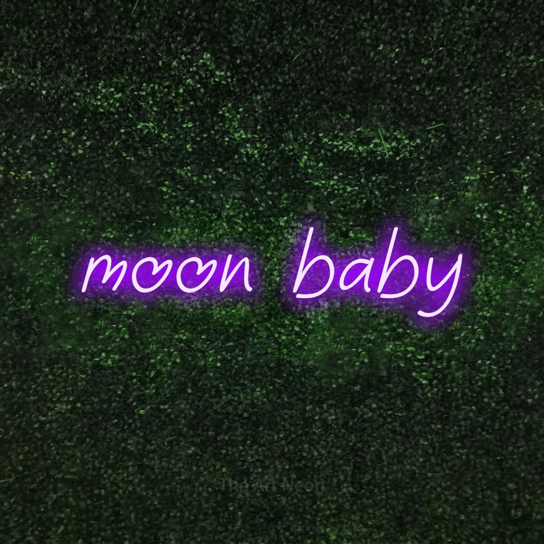 Purple LED neon sign reading "Moon Baby" against a textured green moss wall for nursery décor