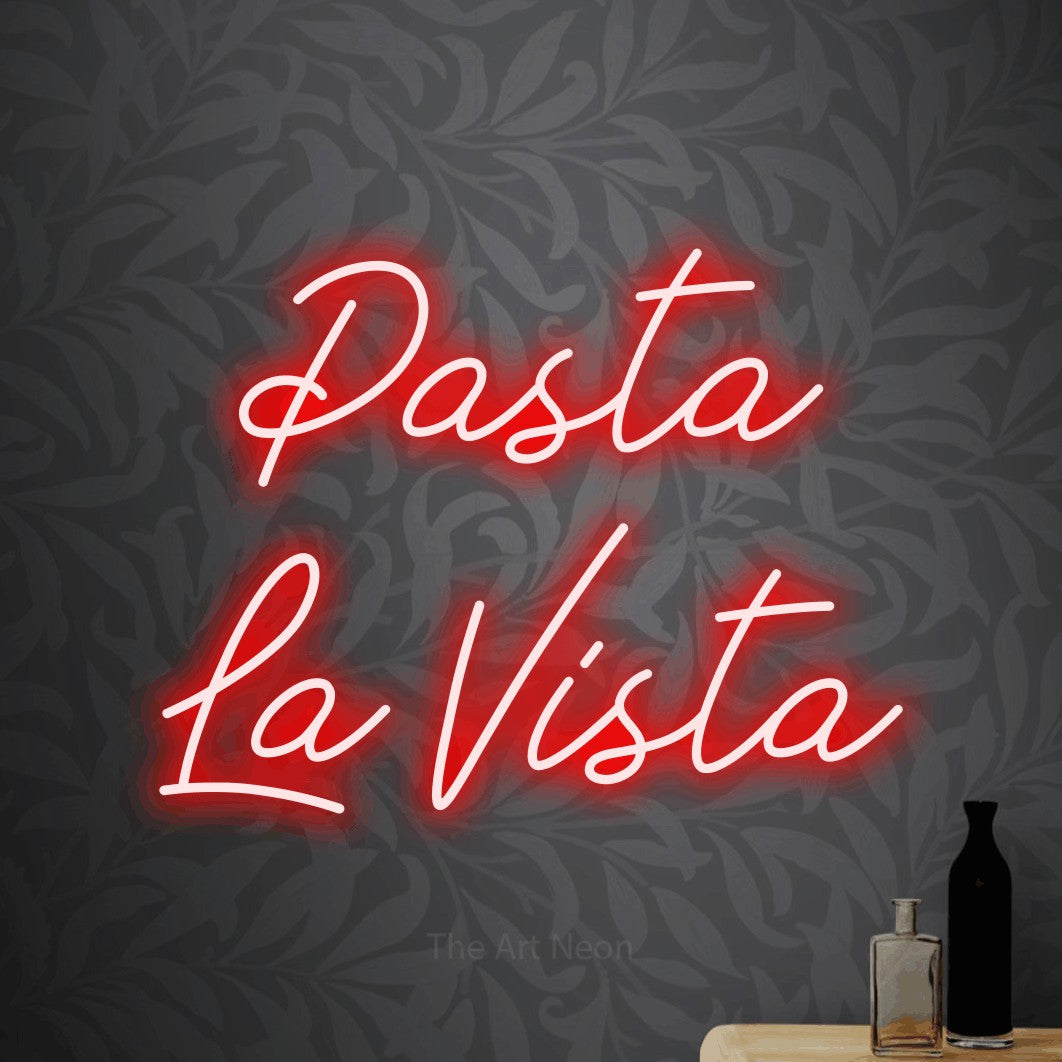 Red script-style LED neon sign reading "Pasta La Vista" against light grey floral wallpaper for kitchen décor