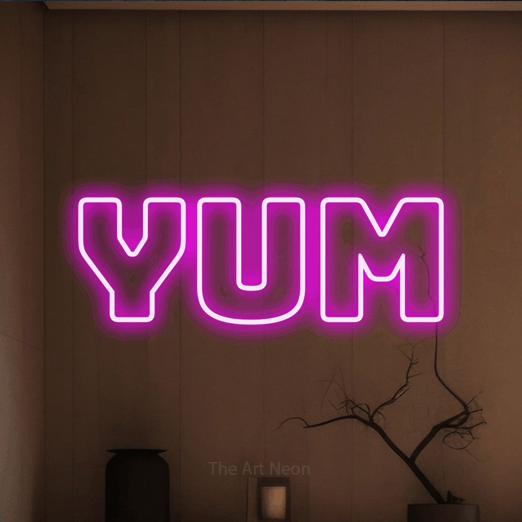 Pink outline-style LED neon sign reading "Yum" against a warm brown wall for kitchen décor