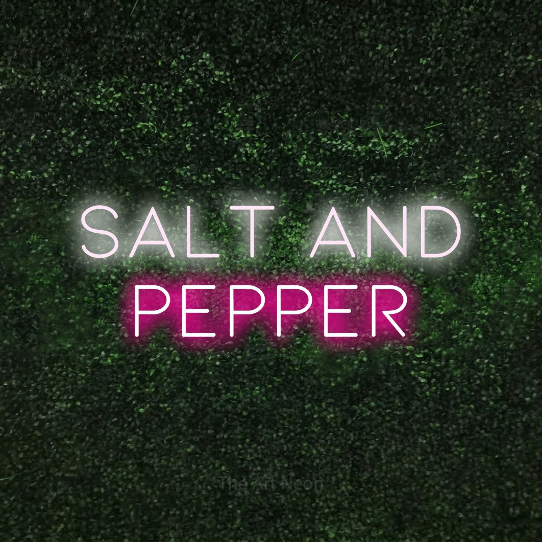 Hot pink and cool white LED neon sign reading "Salt and Pepper" against a textured green moss wall for kitchen décor
