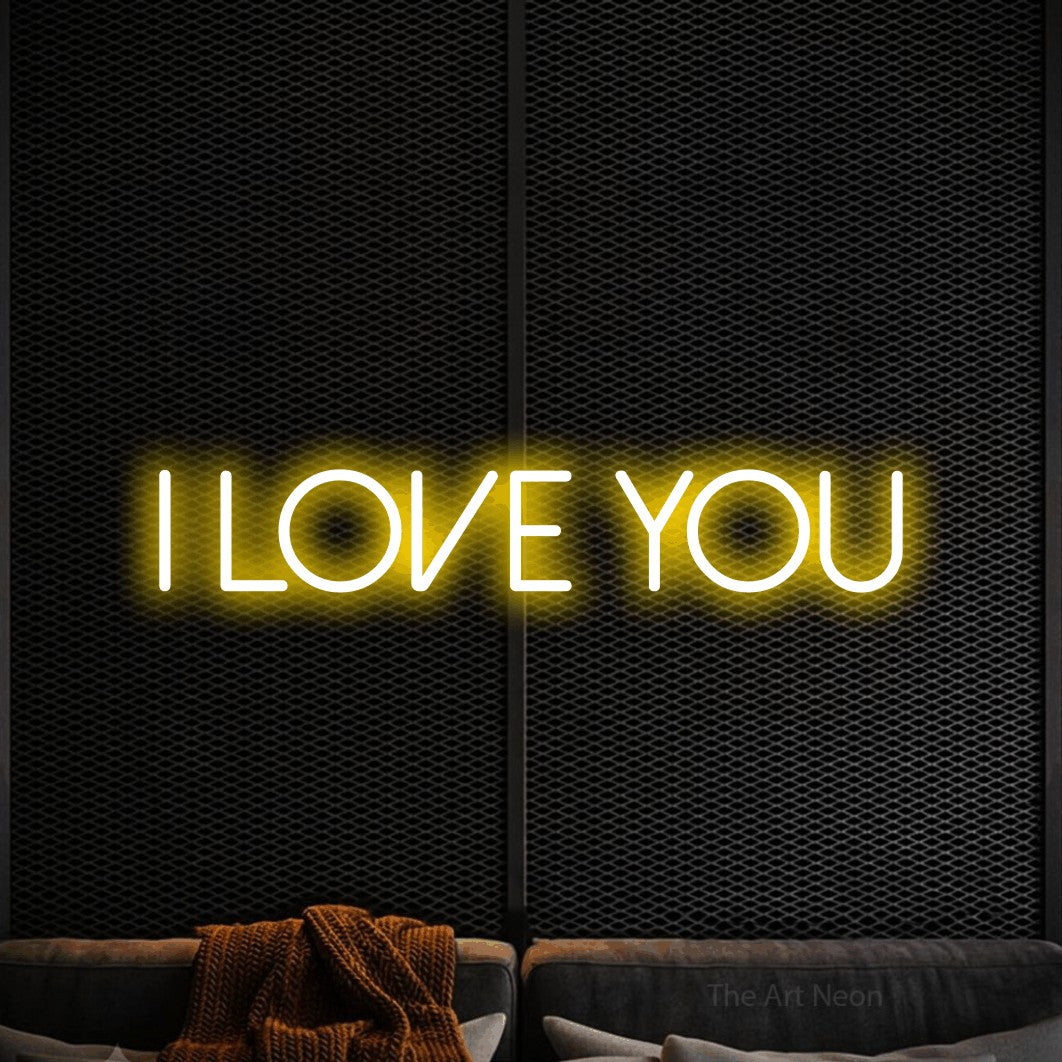 Yellow LED neon sign reading "I Love You" against a black textured wall