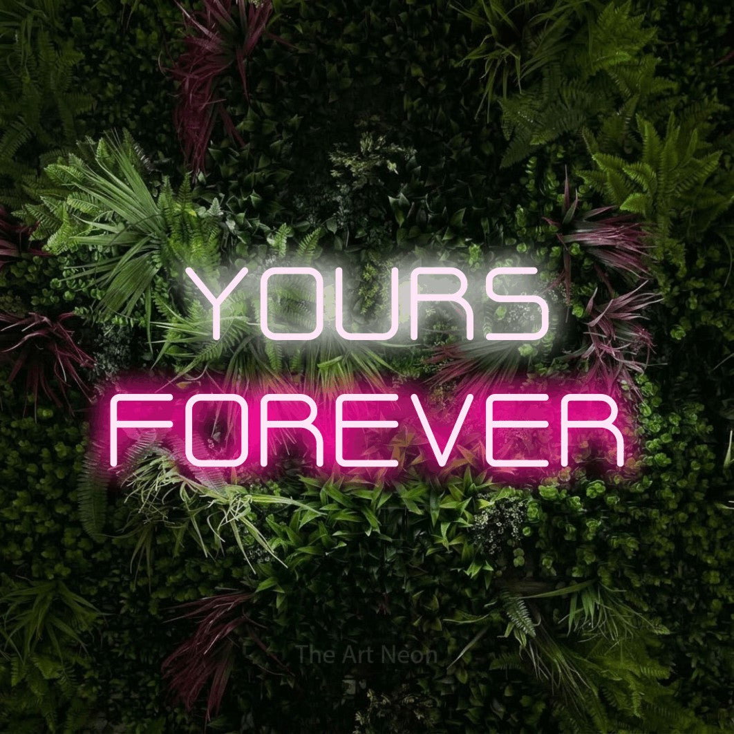 Hot pink and cool white LED neon sign reading "Yours Forever" against a lush garden wall with pink flowers