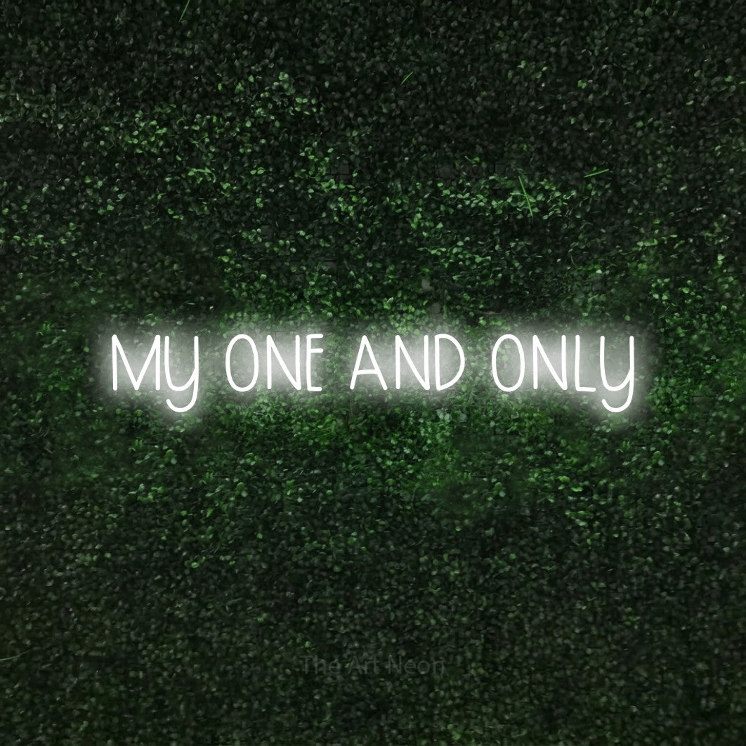 Cool white LED neon sign reading "My One and Only" against a textured green moss wall
