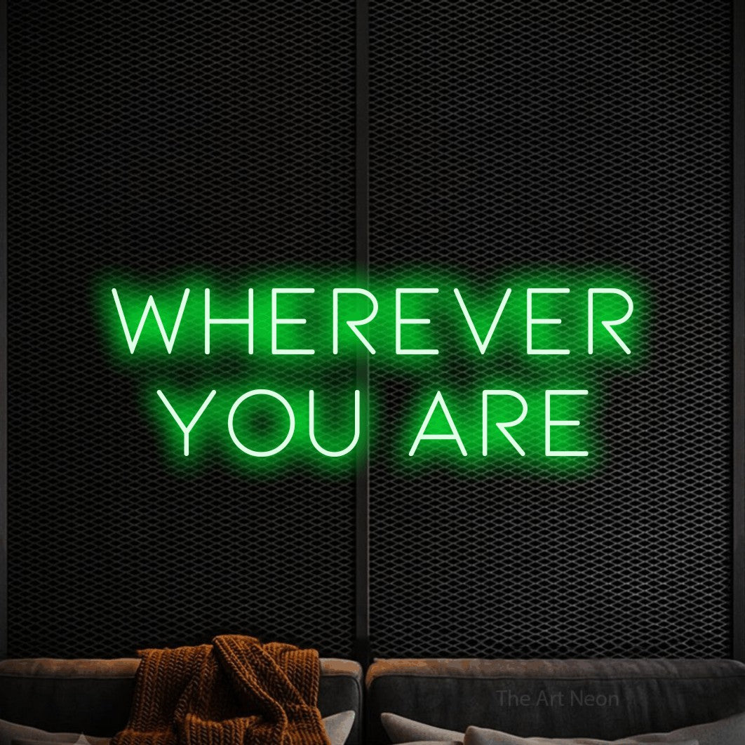 Green LED neon sign reading "Wherever You Are" against a black textured wall