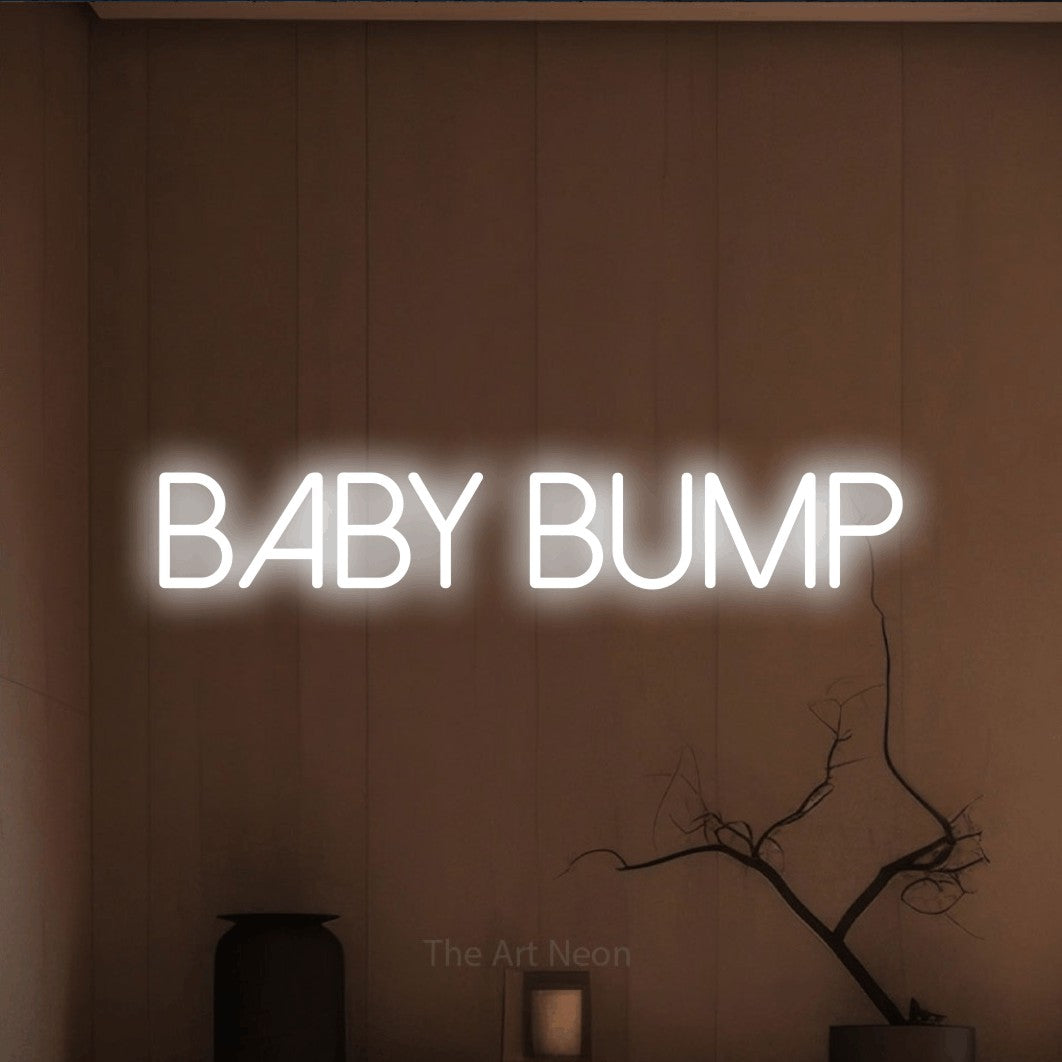 Cool white LED neon sign reading "Baby Bump" against a warm brown wall