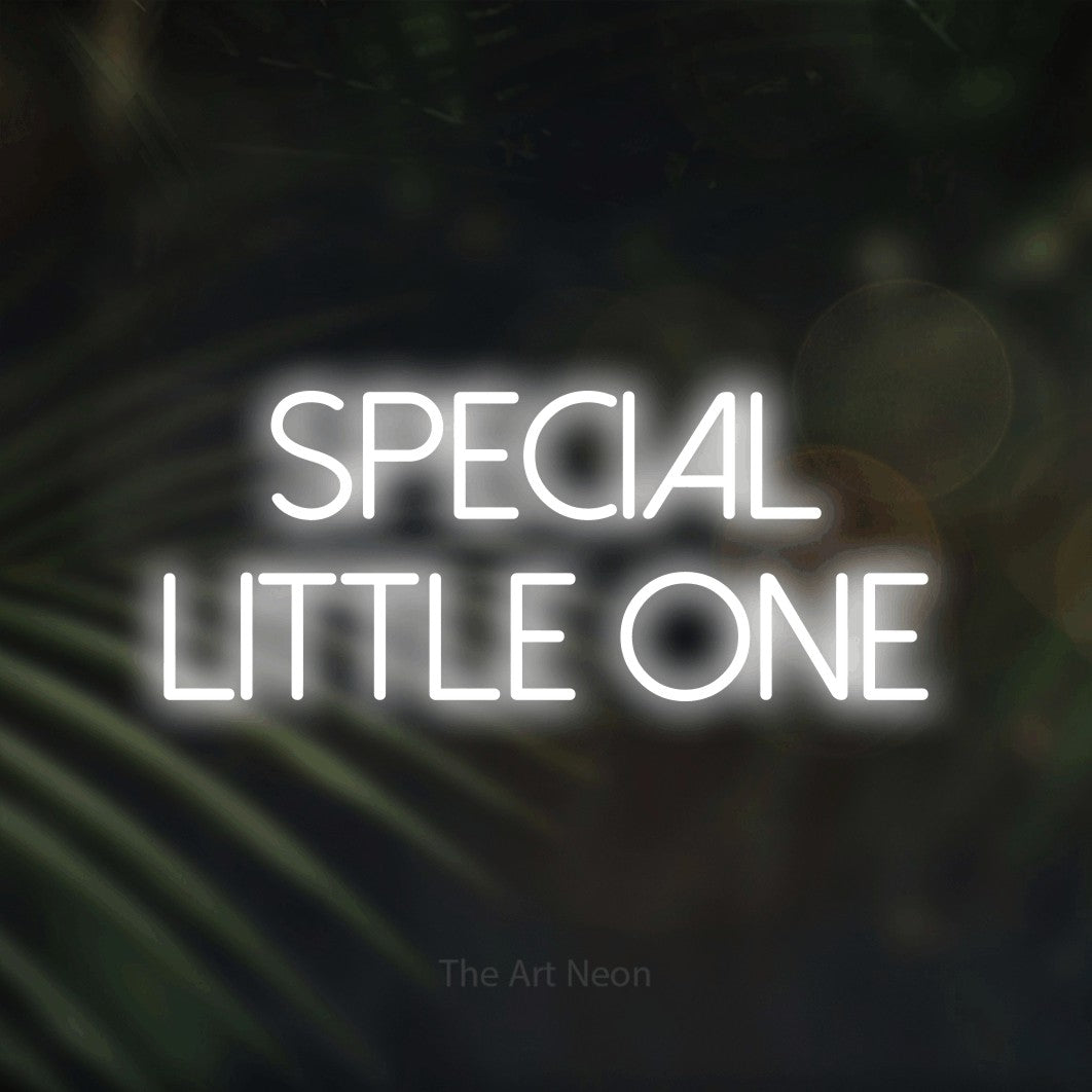 Cool white LED neon sign reading "Special Little One" against dark blurred palm leaves