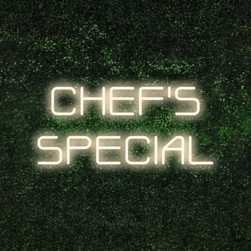 Warm white LED neon sign reading "Chef's Special" against a textured green moss wall for restaurant décor