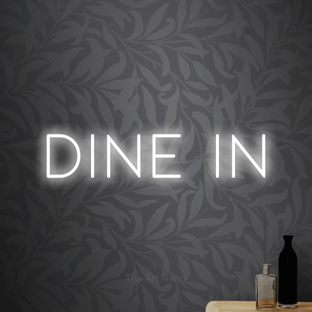 Cool white LED neon sign reading "Dine In" against light grey floral wallpaper for restaurant décor