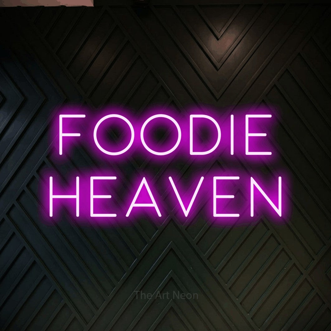 Pink LED neon sign reading "Foodie Heaven" against a dark geometric wood wall for restaurant décor