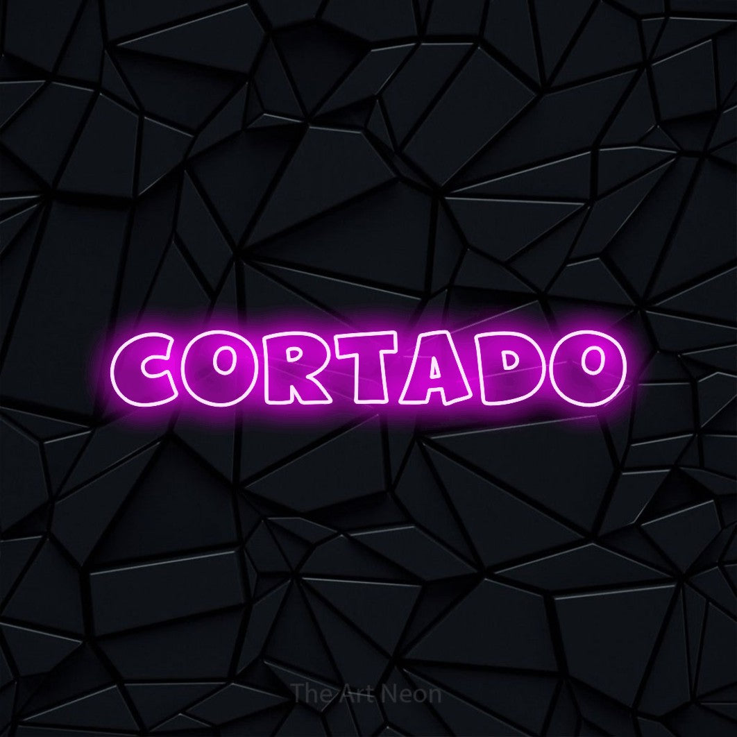 Pink outline-style LED neon sign reading "Cortado" against a black faceted wall for café décor