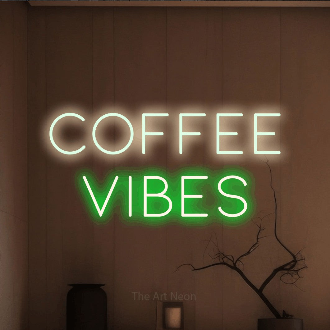 Green and warm white LED neon sign reading "Coffee Vibes" against a warm brown wall for café décor
