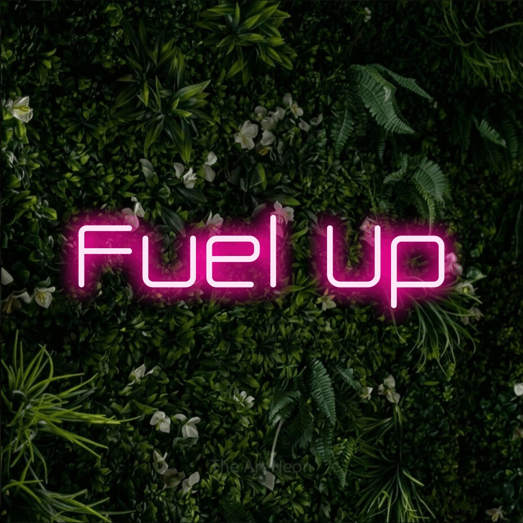 Hot pink LED neon sign reading "Fuel Up" against a leafy green wall for café décor