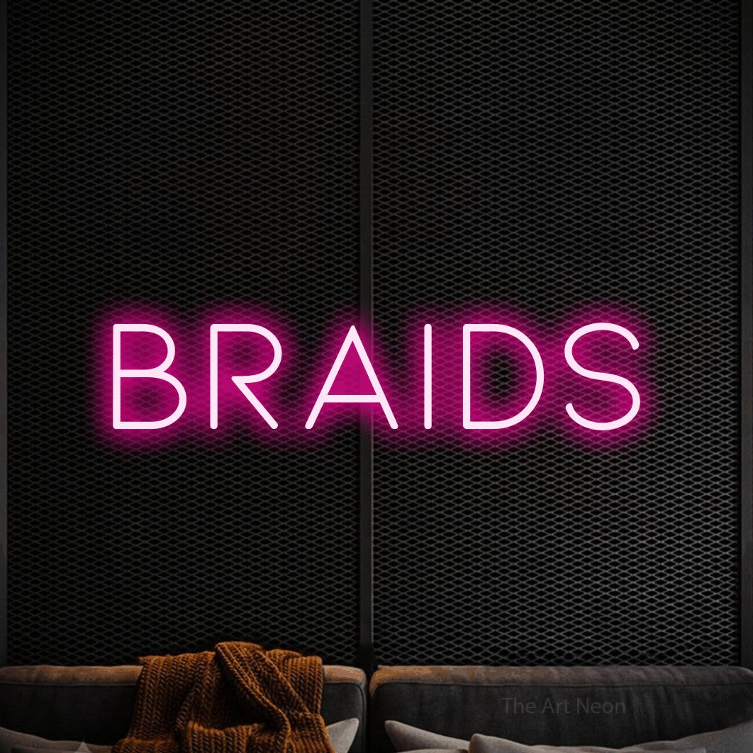 Hot pink LED neon sign reading "Braids" against a black textured wall for salon décor