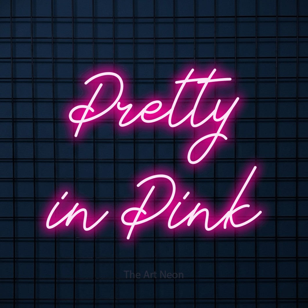 Hot pink script-style LED neon sign reading "Pretty in Pink" against a dark blue tiled wall for salon décor