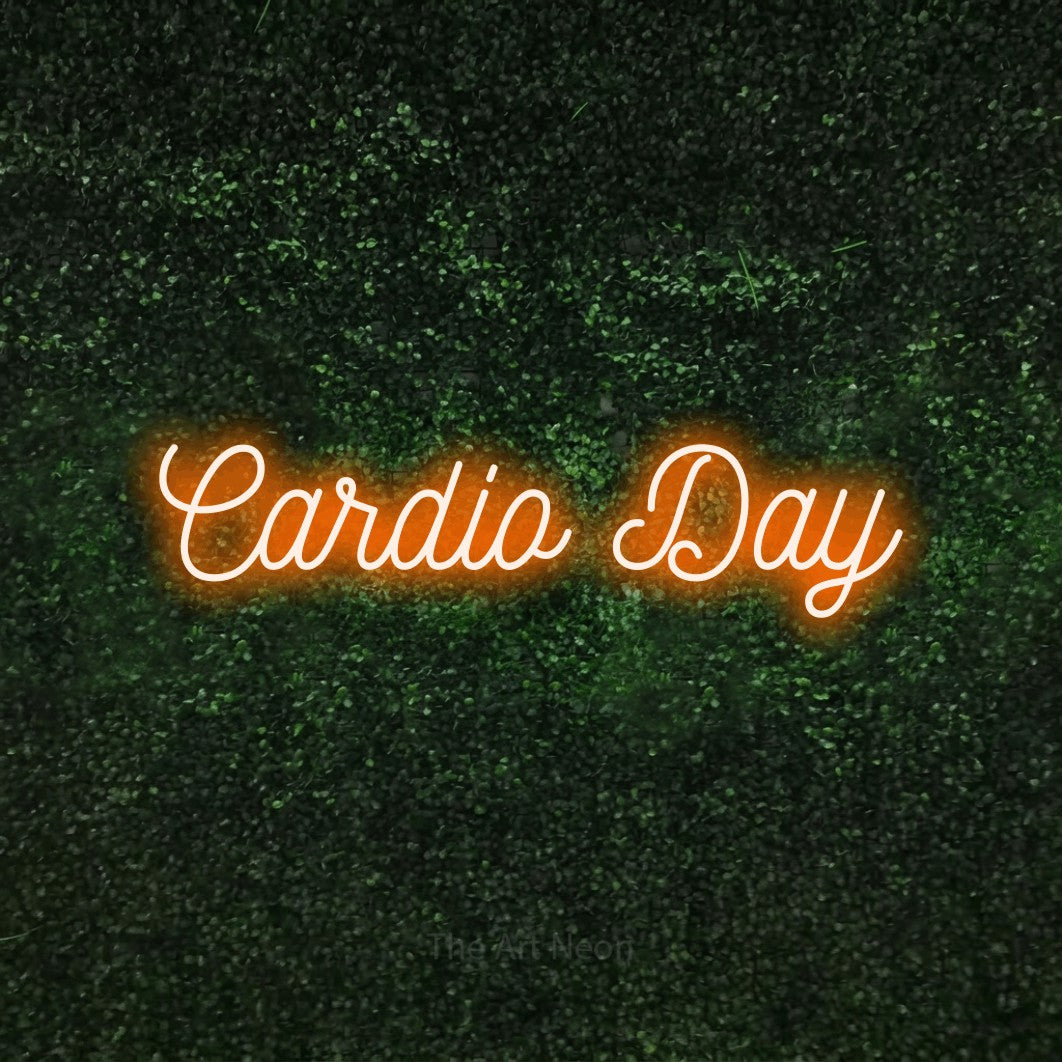 Orange script-style LED neon sign reading "Cardio Day" against a textured green moss wall for gym décor
