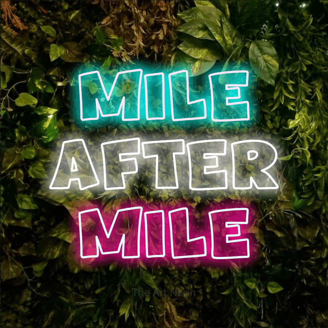 Multicolour outline-style LED neon sign reading "Mile After Mile" against a textured moss and foliage wall for gym décor