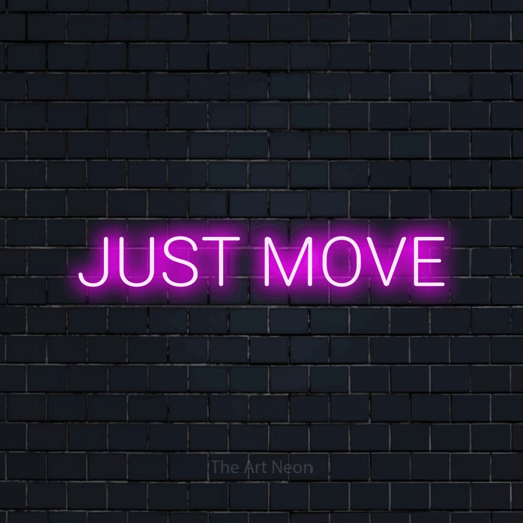 Pink LED neon sign reading "Just Move" against a dark navy brick wall for gym décor