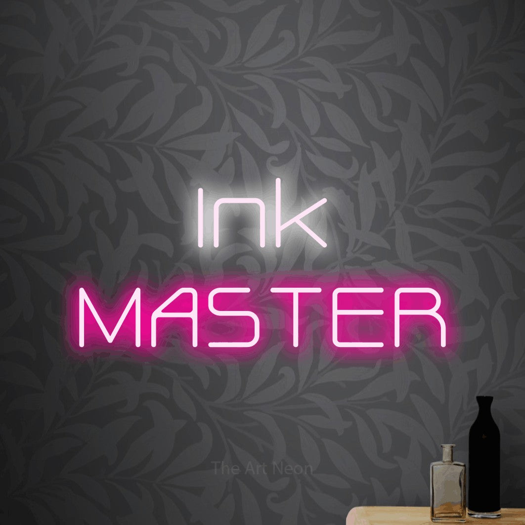 Hot pink and cool white LED neon sign reading "Ink Master" against light grey floral wallpaper for tattoo studio décor