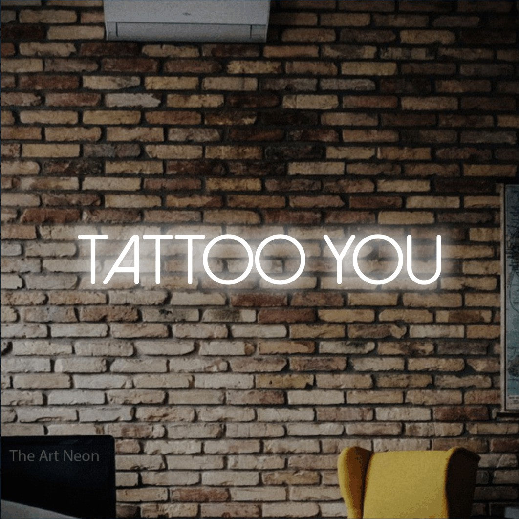 Cool white LED neon sign reading "Tattoo You" against a rustic brick wall for tattoo studio décor