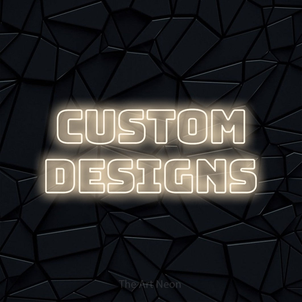 Warm white outline-style LED neon sign reading "Custom Designs" against a black faceted wall for tattoo studio décor
