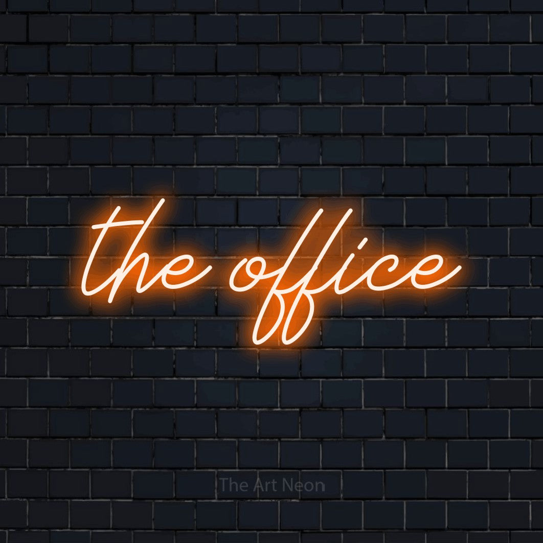 Orange script-style LED neon sign reading "The Office" against a dark navy brick wall for office décor