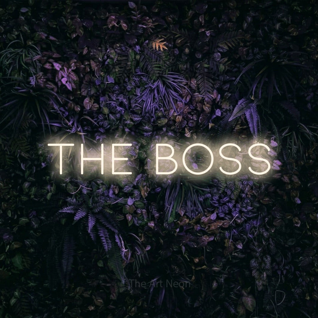 Warm white LED neon sign reading "The Boss" against a purple floral wall for office décor