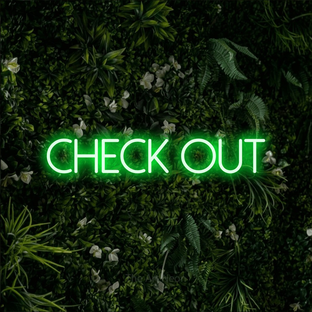 Green LED neon sign reading "Check Out" against a leafy green wall for hotel décor