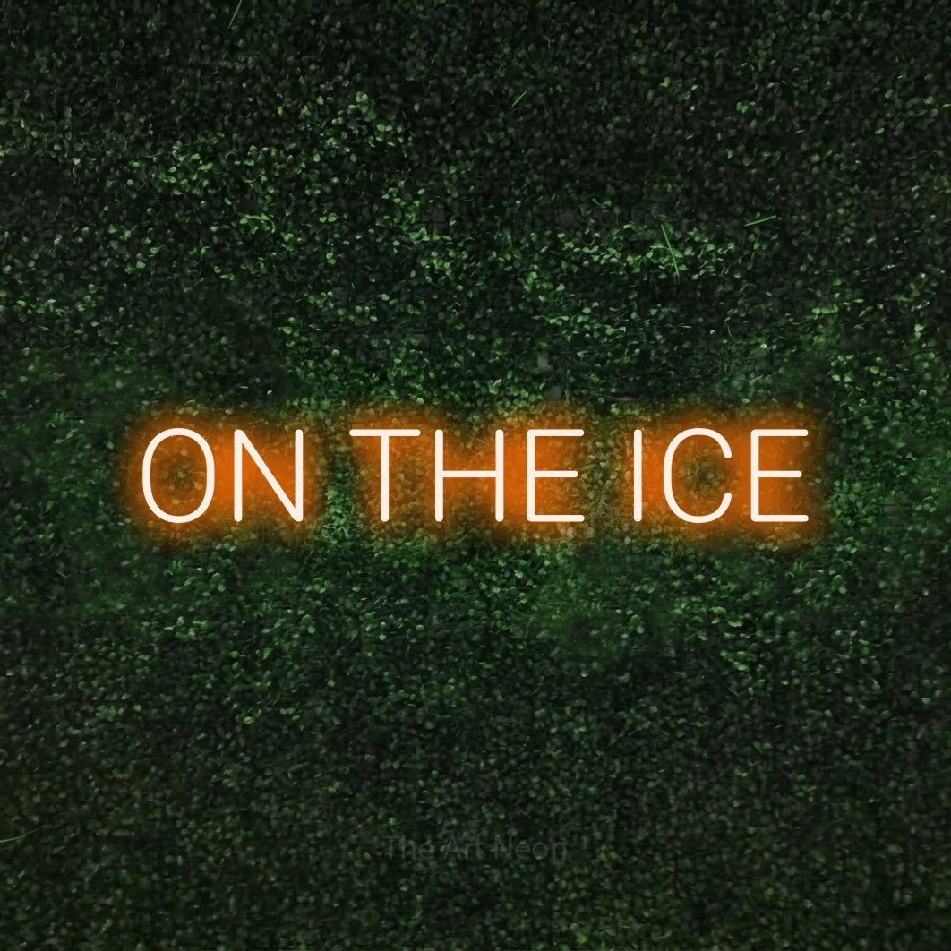 Orange LED neon sign reading "On the Ice" against a textured green moss wall