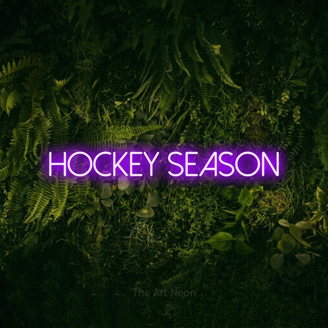 Purple LED neon sign reading "Hockey Season" against a moss-covered green wall