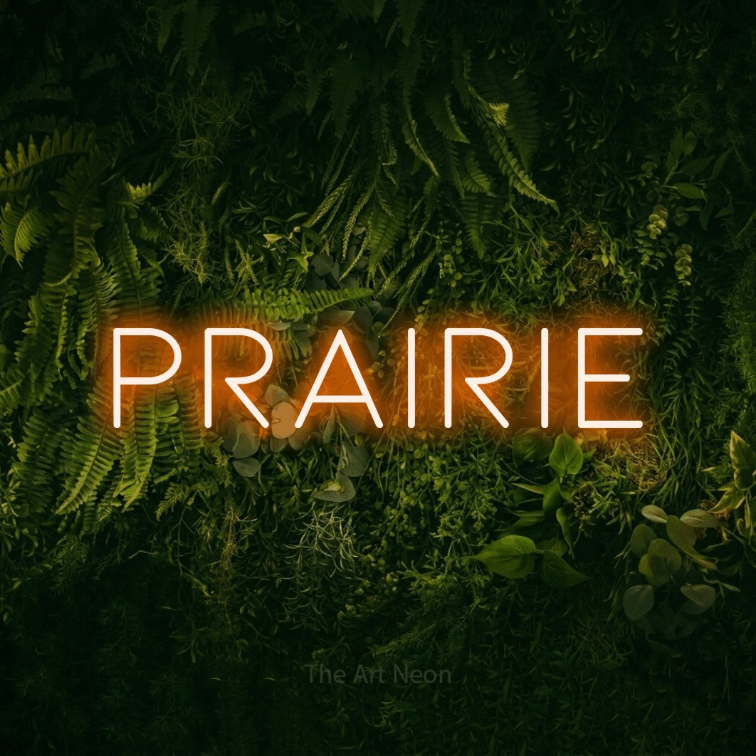 Orange LED neon sign reading "Prairie" against a moss-covered green wall