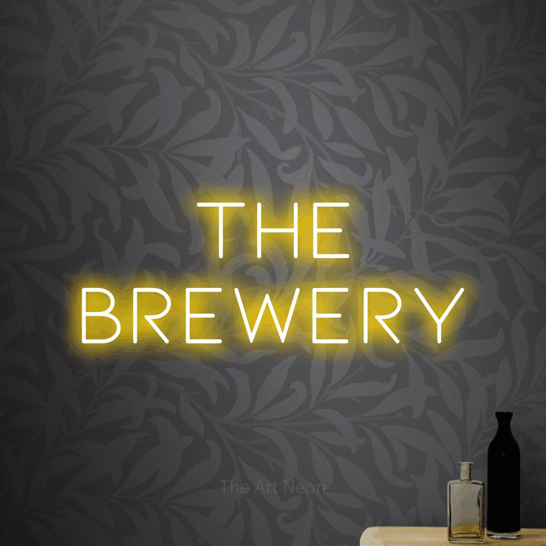 Yellow LED neon sign reading "The Brewery" against light grey floral wallpaper