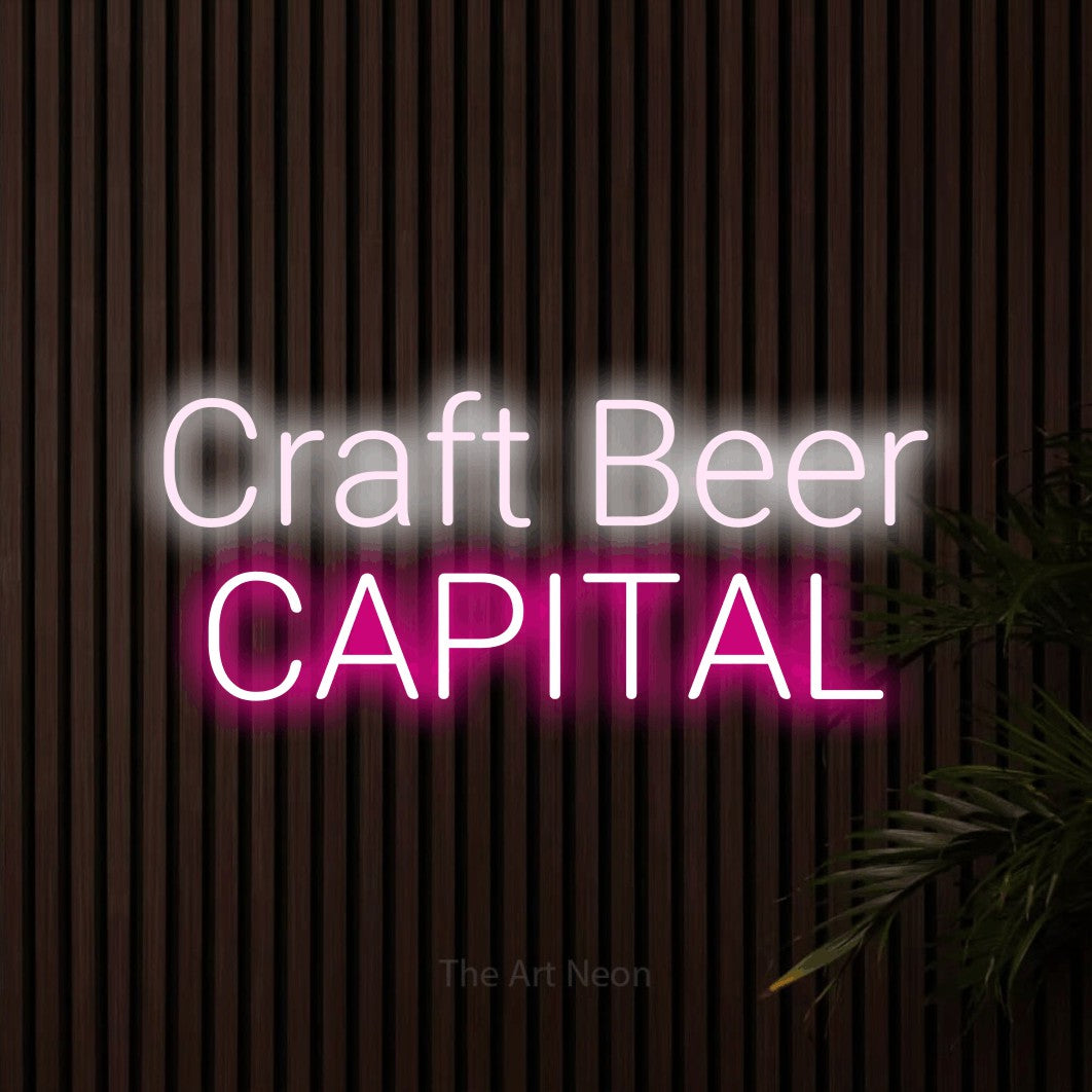 Hot pink and cool white LED neon sign reading "Craft Beer Capital" against dark wooden slats