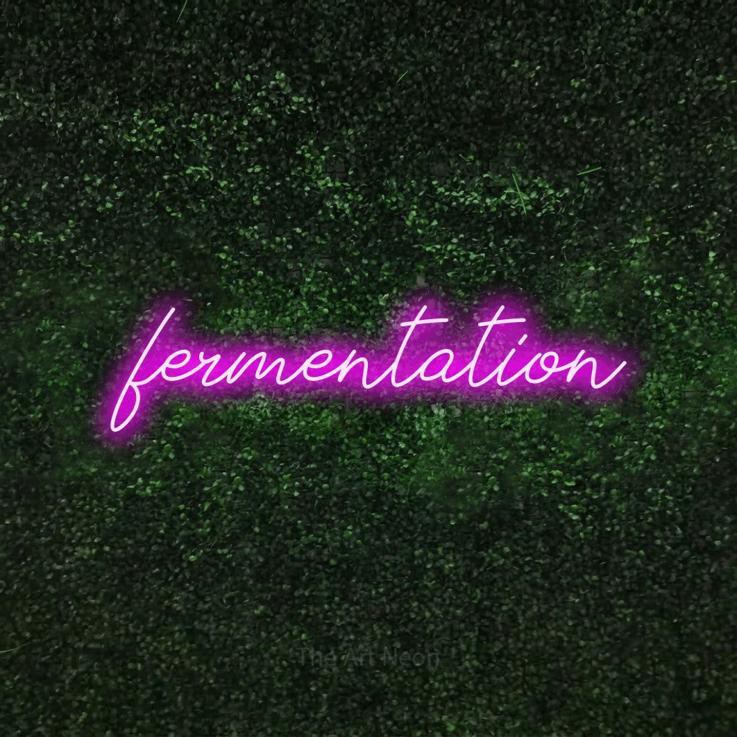 Pink script-style LED neon sign reading "Fermentation" against a textured green moss wall