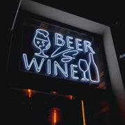 White Beer vs Wine LED neon sign with beer glass and wine bottle artwork, installed in a window