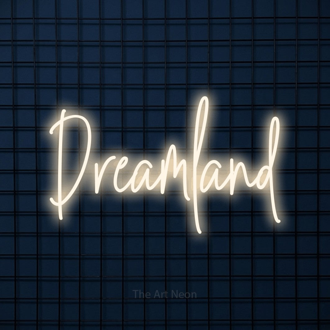 Warm white script-style LED neon sign reading "Dreamland" against a dark blue tiled wall for bedroom décor