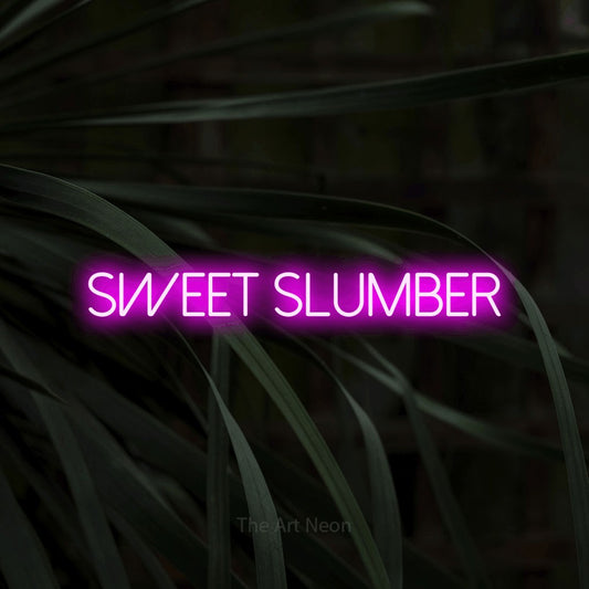 Pink LED neon sign reading "Sweet Slumber" against dark tropical leaves for bedroom décor