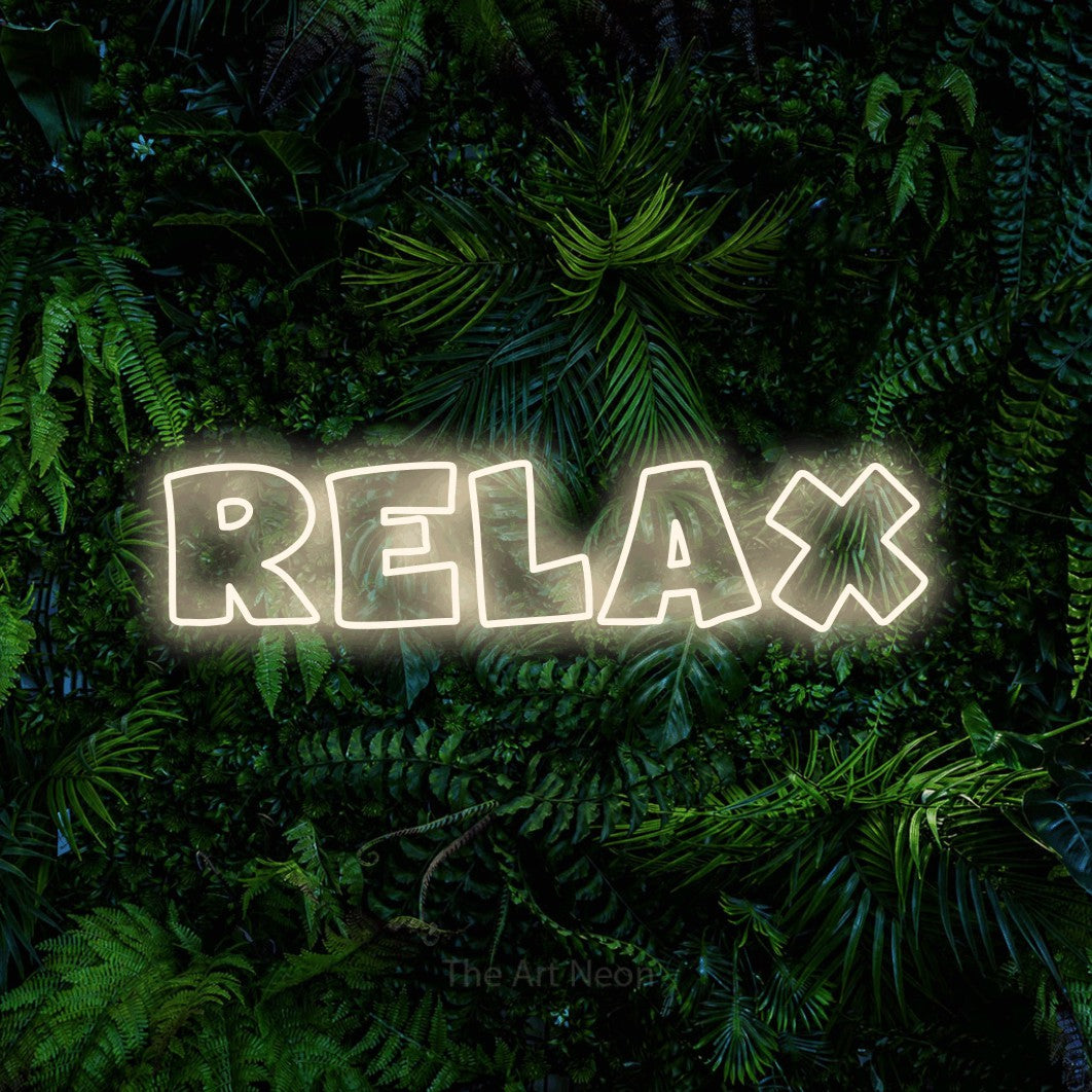 Warm white outline-style LED neon sign reading "Relax" against a dense tropical foliage wall for bedroom décor