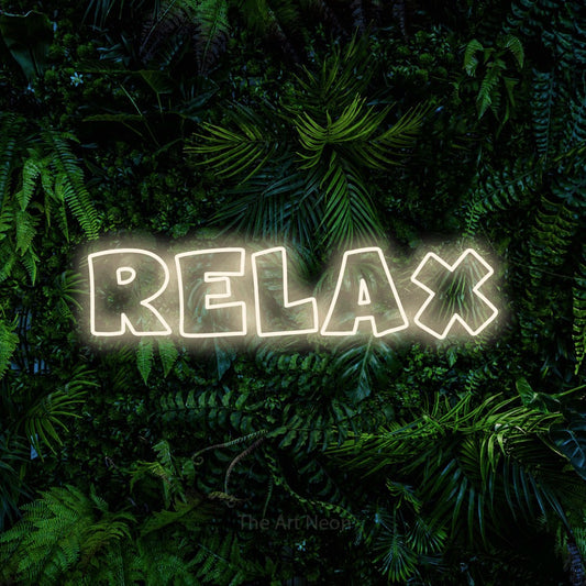 Warm white outline-style LED neon sign reading "Relax" against a dense tropical foliage wall for bedroom décor
