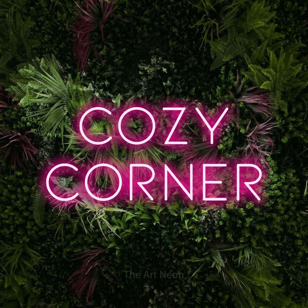 Hot pink LED neon sign reading "Cozy Corner" against a lush garden wall with pink flowers for bedroom décor