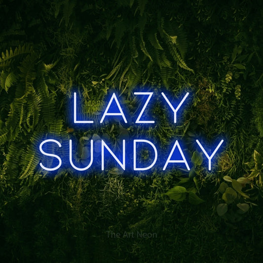 Blue LED neon sign reading "Lazy Sunday" against a moss-covered green wall for bedroom décor