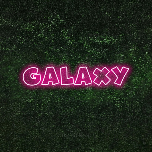 Hot pink outline-style LED neon sign reading "Galaxy" against a textured green moss wall for bedroom décor