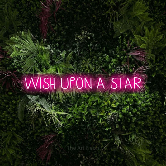 Hot pink LED neon sign reading "Wish Upon a Star" against a lush garden wall with pink flowers for bedroom décor