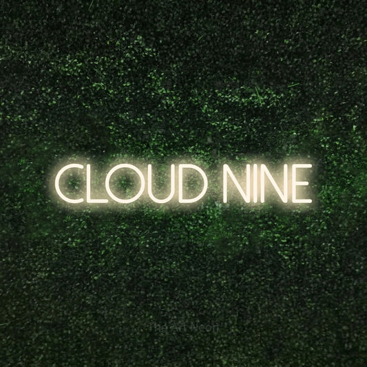 Warm white LED neon sign reading "Cloud Nine" against a textured green moss wall for bedroom décor