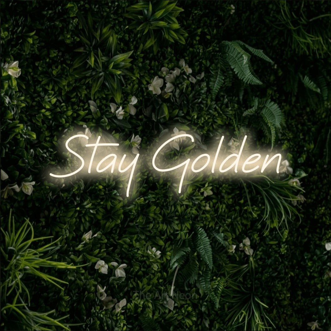 Warm white LED neon sign reading "Stay Golden" against a leafy green wall for bedroom décor