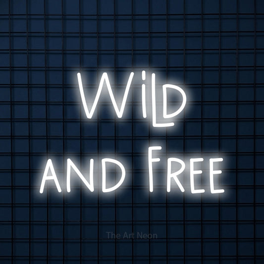 Cool white LED neon sign reading "Wild and Free" against a dark blue tiled wall for bedroom décor