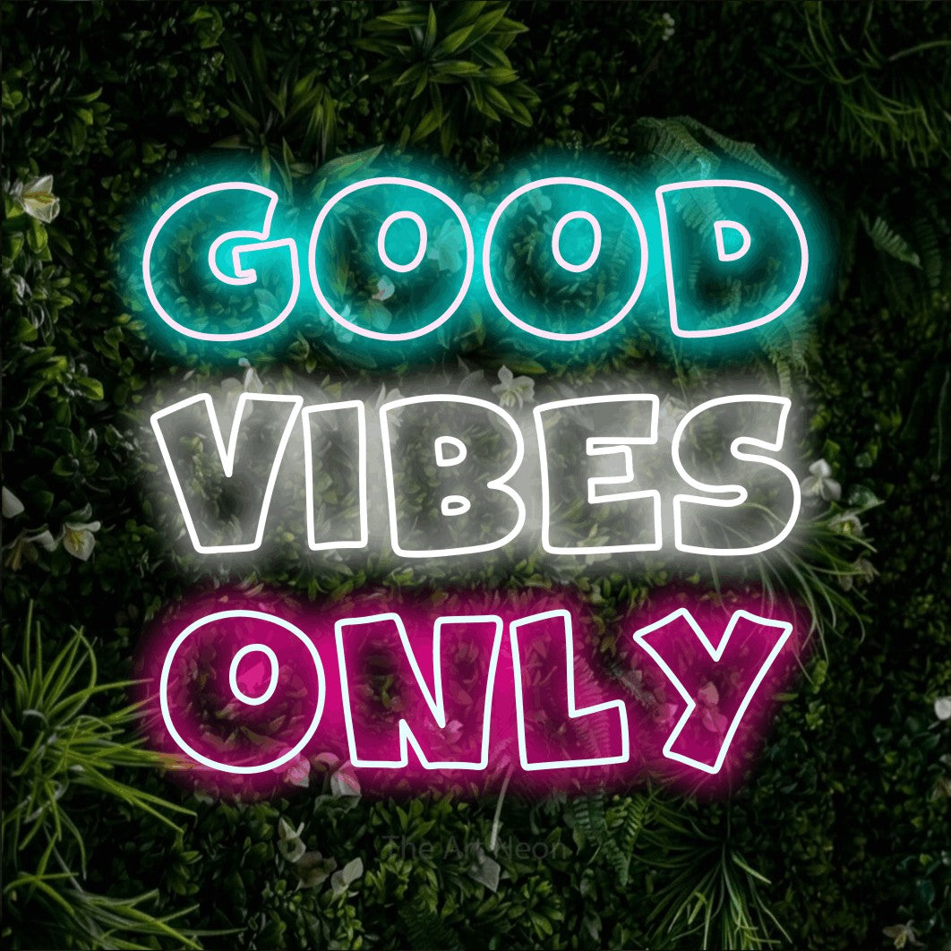 Multicolour outline-style LED neon sign reading "Good Vibes Only" against a leafy green wall for bedroom décor