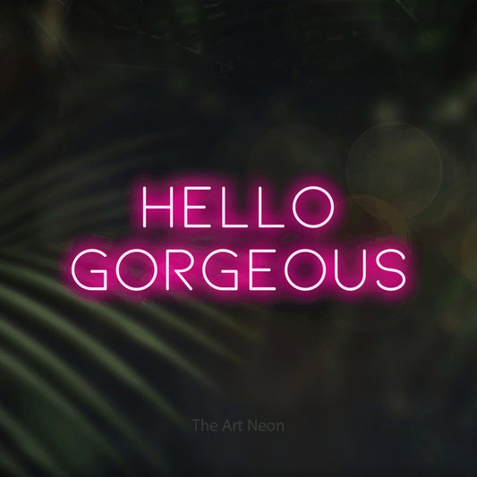 Hot pink LED neon sign reading "Hello Gorgeous" against dark blurred palm leaves for bedroom décor